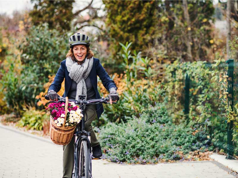 woman cycling as one of the best exercises for varicose vein symptoms